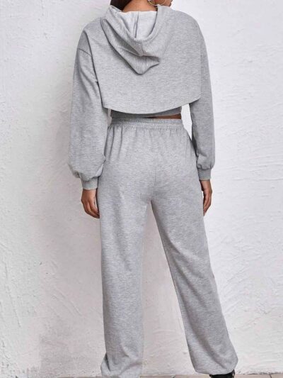 Women's fitness tracksuit and joggers set. Heather grey marl fabric, visible fine stitching. Soft, comfortable gym apparel.
