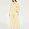Women's track suit set: soft-looking, coral fleece. Ribbed cuffs, drawstrings. Custom design potential evident. Comfort & sty