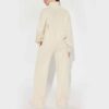 Women's track suit set: soft-looking, coral fleece. Ribbed cuffs, drawstrings. Custom design potential evident. Comfort & sty