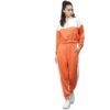 Velour tracksuit for women. Soft, plush texture. Note custom logo detail. Two-piece set in a rich, inviting hue. Quality stit