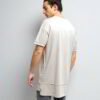 Stack of youth t-shirts. Soft cotton knit texture, clean seams. Various colors hinted: red, green, blue. Basic crewneck style