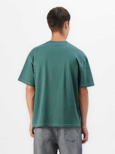 Oversized t-shirt, chest pocket detail. Soft jersey knit with visible dropshoulder seam. Hints of heather gray. Relaxed fit.