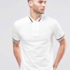Close-up: Navy polo shirt. Fine pique knit texture, crisp collar, clean stitching. Custom logo embroidery. Professional appar