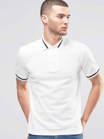 Close-up: Navy polo shirt. Fine pique knit texture, crisp collar, clean stitching. Custom logo embroidery. Professional appar