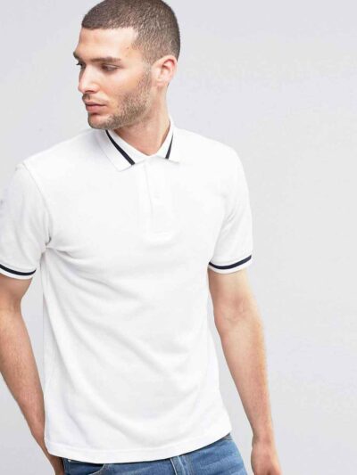 Close-up: Navy polo shirt. Fine pique knit texture, crisp collar, clean stitching. Custom logo embroidery. Professional appar