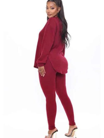 Black plus-size woman in a skinny fit tracksuit. Notice the smooth, matte fabric & strong, neat stitching. Figure-hugging sty