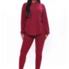 Black plus-size woman in a skinny fit tracksuit. Notice the smooth, matte fabric & strong, neat stitching. Figure-hugging sty