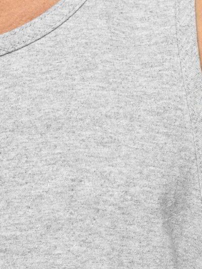 Close-up on a fitted tank top. Soft, breathable fabric, durable stitching. Perfect blank canvas for your custom design. Avail