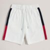 Textured cotton shorts, vibrant custom embroidery detail. Casual streetwear, available in varied colors. Note durable stitchi