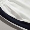 Textured cotton shorts, vibrant custom embroidery detail. Casual streetwear, available in varied colors. Note durable stitchi