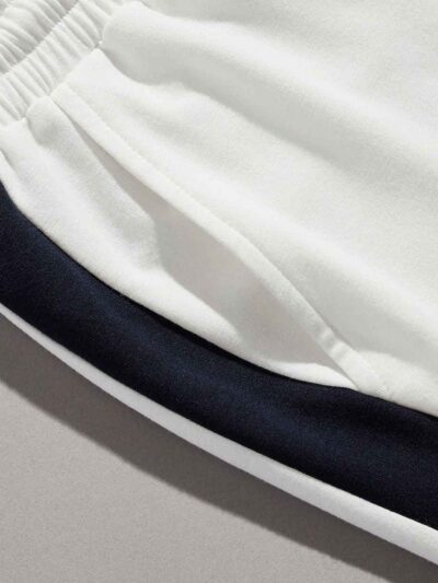 Textured cotton shorts, vibrant custom embroidery detail. Casual streetwear, available in varied colors. Note durable stitchi