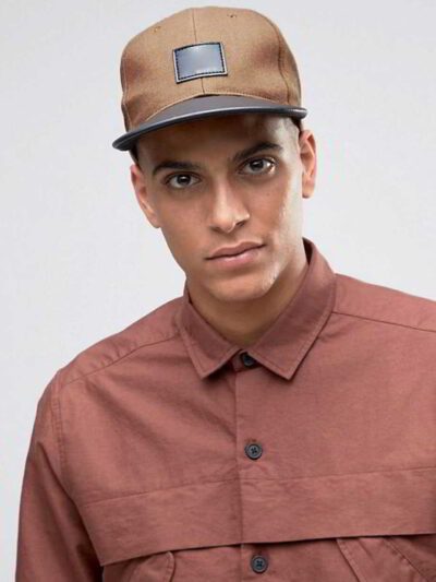 Close-up of custom baseball cap. Embroidered design, curved brim, adjustable back. Textured twill fabric, vibrant colors, dur
