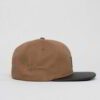 Close-up of custom baseball cap. Embroidered design, curved brim, adjustable back. Textured twill fabric, vibrant colors, dur