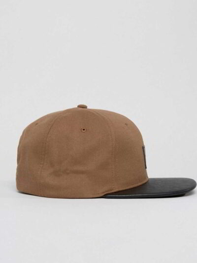 Close-up of custom baseball cap. Embroidered design, curved brim, adjustable back. Textured twill fabric, vibrant colors, dur