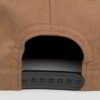 Close-up of custom baseball cap. Embroidered design, curved brim, adjustable back. Textured twill fabric, vibrant colors, dur
