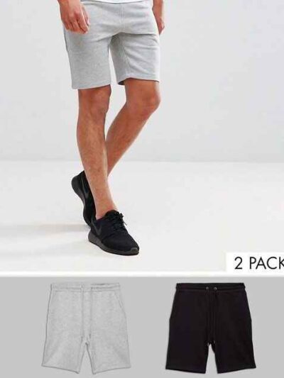Athletic training shorts, close-up showing breathable woven fabric, reinforced stitching. Performance garment, likely navy or