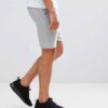 Athletic training shorts, close-up showing breathable woven fabric, reinforced stitching. Performance garment, likely navy or