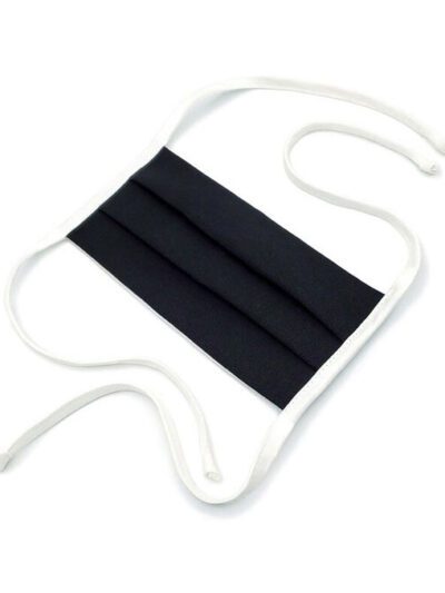 Close-up of finely stitched cotton face mask. Soft, textured fabric in light grey. Washable, reusable, breathable facial cove