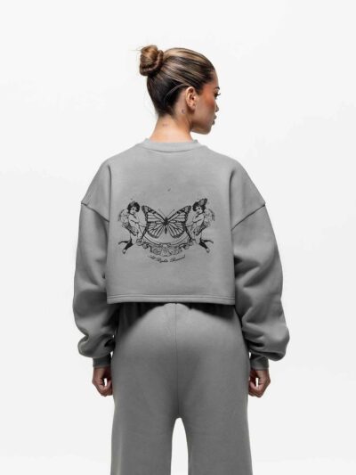 Ladies' two-piece tracksuit in soft-focus, muted color. Hooded zip jacket & wide-leg pants. Visible subtle stitching detail.