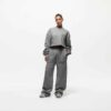 Ladies' two-piece tracksuit in soft-focus, muted color. Hooded zip jacket & wide-leg pants. Visible subtle stitching detail.