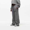 Ladies' two-piece tracksuit in soft-focus, muted color. Hooded zip jacket & wide-leg pants. Visible subtle stitching detail.