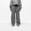 Ladies' two-piece tracksuit in soft-focus, muted color. Hooded zip jacket & wide-leg pants. Visible subtle stitching detail.