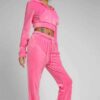Heather gray women's jogger and hoodie set. Soft, looped knit with subtle embroidery detail. Casual athletic wear. Comfortabl