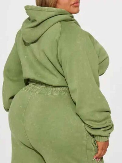 Close-up of a cotton women's tracksuit set in warm autumn hues. Soft, textured knit with detailed stitching. Relaxed fit, cus
