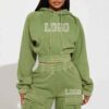 Close-up of a cotton women's tracksuit set in warm autumn hues. Soft, textured knit with detailed stitching. Relaxed fit, cus