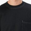 Black oversized t-shirt with contrast white stitching, drop shoulders, pocket. Soft, textured fabric. Custom logo imprint are