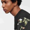 Lightweight tee with vibrant tropical print pocket. Soft cotton, neat stitching. Casual short-sleeve shirt, summery vibe. - V
