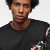 Lightweight tee with vibrant tropical print pocket. Soft cotton, neat stitching. Casual short-sleeve shirt, summery vibe. - V