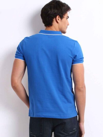 Close-up: Textured navy polo shirt, pique knit, clean stitching. Customization-ready. Breathable, durable fabric. Bulk polo s
