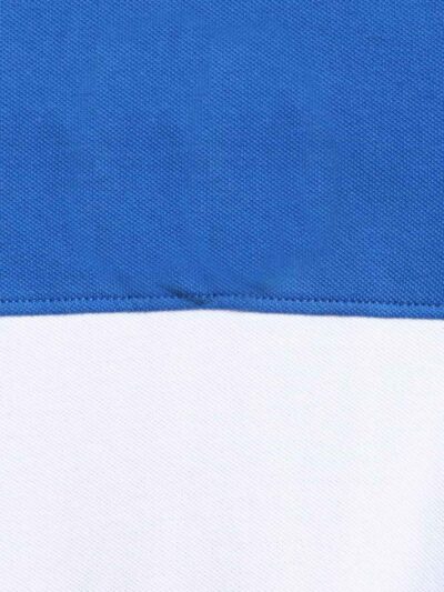 Close-up: Textured navy polo shirt, pique knit, clean stitching. Customization-ready. Breathable, durable fabric. Bulk polo s