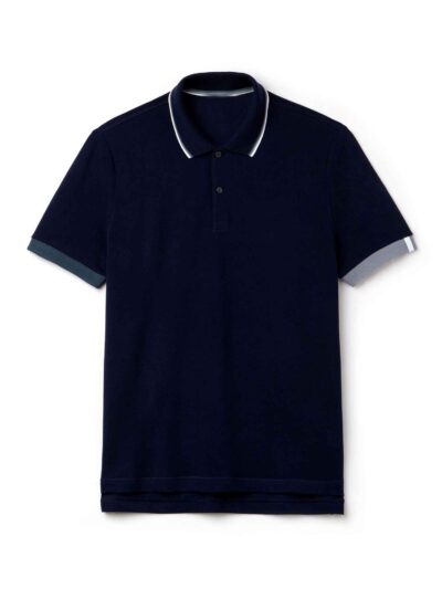 Close-up of a finely knit polo shirt, hints of navy and white. Sharp collar, clean stitching. Classic menswear garment detail