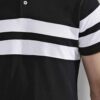 Close-up of a navy polo shirt showcasing fine pique knit texture, clean stitching. Short-sleeved, classic collar, perfect for