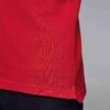 Close-up of a navy polo. Fine pique knit texture, crisp collar, clean three-button placket with reinforced stitching. Ideal g
