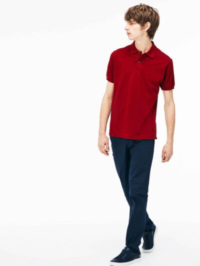 Close-up of hospitality polo shirt. Breathable knit fabric, fine stitching. Burgundy color with subtle contrast collar detail