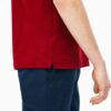 Close-up of hospitality polo shirt. Breathable knit fabric, fine stitching. Burgundy color with subtle contrast collar detail