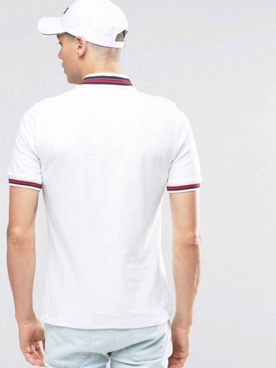 Close-up of navy polo shirt. Fine pique knit, clean stitching detail. Business casual team uniform. Breathable & durable. - V