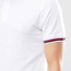 Close-up of navy polo shirt. Fine pique knit, clean stitching detail. Business casual team uniform. Breathable & durable. - V