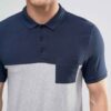 Close-up of navy polo shirt; fine knit fabric, clean stitching. Perfect for professional attire and team wear. Note custom bu