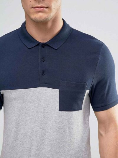 Close-up of navy polo shirt; fine knit fabric, clean stitching. Perfect for professional attire and team wear. Note custom bu