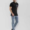 Close-up of a navy polo shirt, embroidered logo detail on chest, subtle pique knit texture, clean, precise stitching. - View