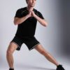 Men's oversized tee and shorts set, textured fabric, custom embroidery detail. Relaxed fit, soft drape. Likely cotton blend,
