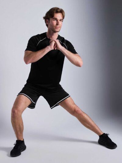 Men's oversized tee and shorts set, textured fabric, custom embroidery detail. Relaxed fit, soft drape. Likely cotton blend,