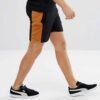 Lightweight drawstring beach shorts with vibrant print. Note fine stitching and soft, textured fabric. Summer casual wear. -
