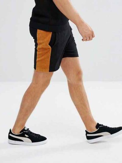 Lightweight drawstring beach shorts with vibrant print. Note fine stitching and soft, textured fabric. Summer casual wear. -