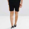 Lightweight drawstring beach shorts with vibrant print. Note fine stitching and soft, textured fabric. Summer casual wear. -