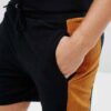 Lightweight drawstring beach shorts with vibrant print. Note fine stitching and soft, textured fabric. Summer casual wear. -